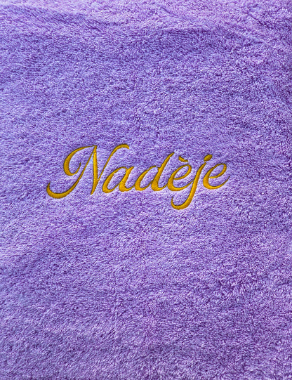 Serviette brodée Mamie — broderie dorée sur fond lilas